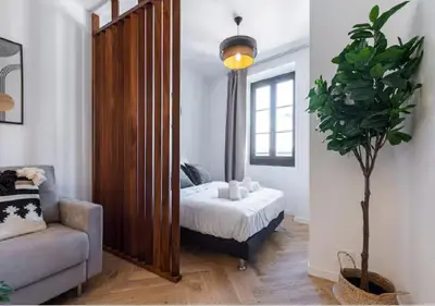a bedroom with a bed and a large mirror at Carre dOr Design Confort and Centralité in Nice