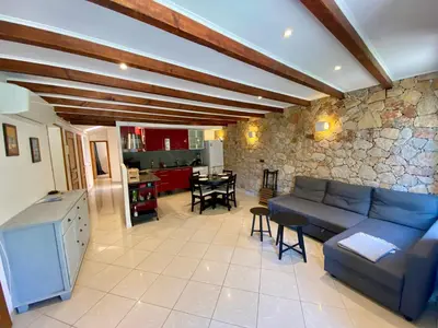 a living room with a couch and a stone wall at T4 Nice Centre - Close to shops, Wi-Fi, AC in Nice