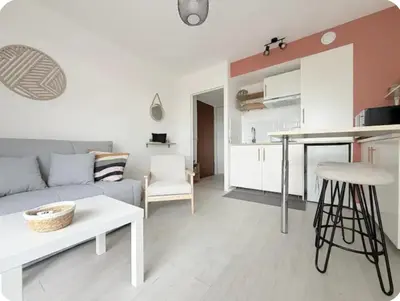 a living room with a couch and a table at Studio Vue Mer Nice in Nice