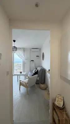 a living room with a couch and a chair and a table at Studio Vue Mer Nice in Nice