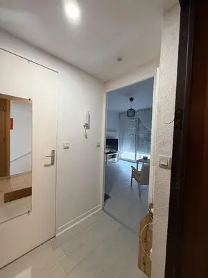 a hallway with a door leading to a living room at Studio Vue Mer Nice in Nice