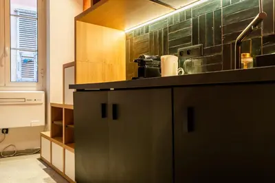 a kitchen with a black counter top in a room at La Casa Nissa in Nice