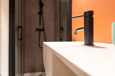 a bathroom with a shower with a sink and a shower at La Casa Nissa in Nice