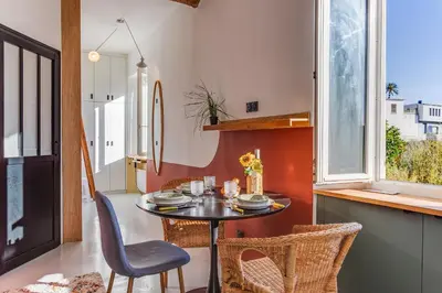 a dining room with a table and chairs and a window at STUDIO AZUR AP4487 By Riviera Holiday Homes in Villefranche-sur-Mer