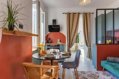 a living room with a table and chairs and a couch at STUDIO AZUR AP4487 By Riviera Holiday Homes in Villefranche-sur-Mer