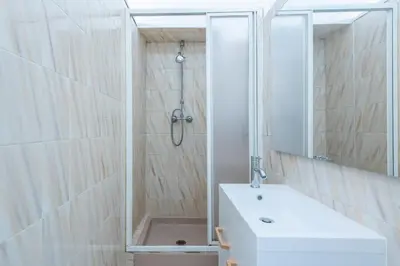 a bathroom with a shower and a sink and a mirror at Happyfew maison Michelet in Nice