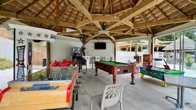 a room with a pool table and ping pong tables at Cosy mobil-home wifi clim in Cagnes-sur-Mer