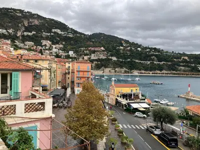 a view of a city with a river and buildings at Duplex Apartment Old Town & Beach in Villefranche-sur-Mer