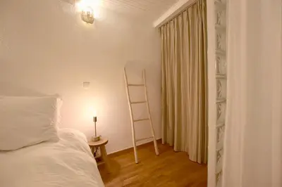 a bedroom with a ladder and a bed and a lamp at Charmant appartement au sein de la vieille ville in Villefranche-sur-Mer