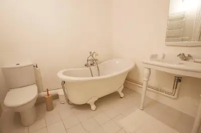 a bathroom with a tub and a toilet and a sink at Charmant appartement au sein de la vieille ville in Villefranche-sur-Mer