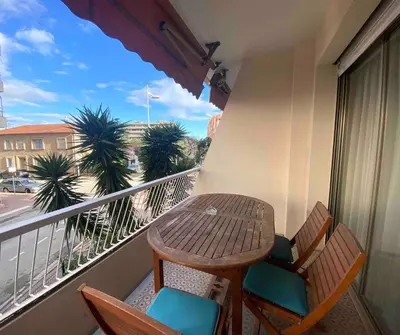 a table and chairs on a balcony with a table at Charming 2-room near beach with terrace in Cagnes-sur-Mer