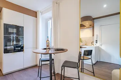 a small kitchen with a table and chairs in a room at Appartement cosy au coeur de Cagnes sur Mer in Cagnes-sur-Mer