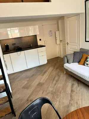 a living room with a couch and a kitchen at Magnifique 2P Vieux Nice AC-WIFI in Nice