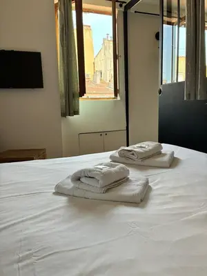 two towels sitting on top of a white bed at Magnifique 2P Vieux Nice AC-WIFI in Nice