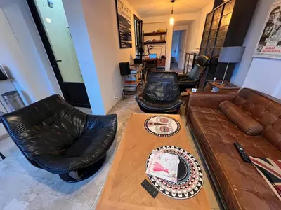 a living room with a couch and a table with a cake at Villa Arty Nice - Vue Mer Panoramique, Piscine & Design in Nice