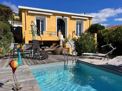 a house with a swimming pool in front of a house at Villa Arty Nice - Vue Mer Panoramique, Piscine & Design in Nice