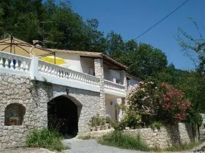 a large stone building with a gate and a fence at Holiday Home Rocabel mit Blick auf das Wasser by Interhome in Gattières
