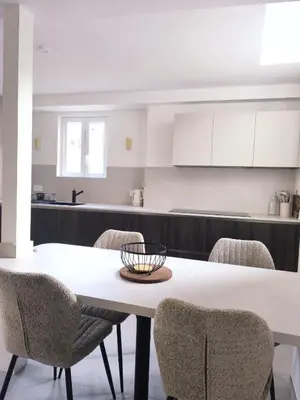 a kitchen with a white table and chairs at Elegant Renovated Apartment Nice Port AC Sleeps 4 in Nice