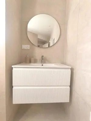 a bathroom with a white sink and a mirror at Elegant Renovated Apartment Nice Port AC Sleeps 4 in Nice