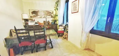a room with a table and chairs and a window at Shared Appartment with Kitten in Nice