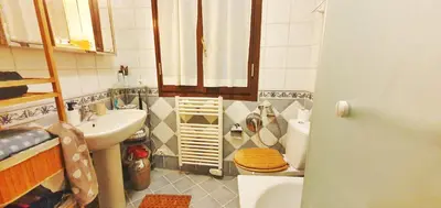 a small bathroom with a toilet and a sink at Shared Appartment with Kitten in Nice