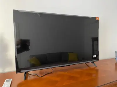 a large television screen with a couch in a room at Cosy Nice Promenade des Anglais Beach Apartment 2 rooms in Nice