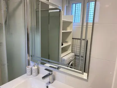 a bathroom with a sink and a mirror at Cosy Nice Promenade des Anglais Beach Apartment 2 rooms in Nice
