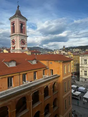 a building with a clock tower in a city at Joli studio rénové vieux Nice in Nice