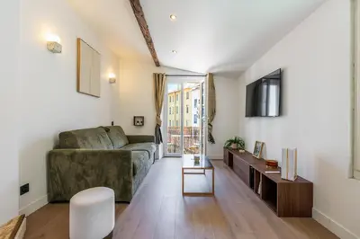 a living room with a couch and a table at Bright 3 rooms apartment close to Place Massena in Nice