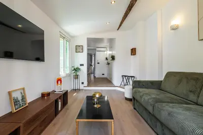 a kitchen and dining room with a table and chairs at Bright 3 rooms apartment close to Place Massena in Nice