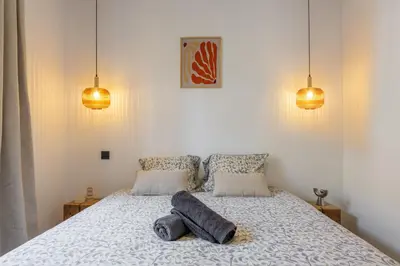 a kitchen and dining room with a table and chairs at Bright 3 rooms apartment close to Place Massena in Nice