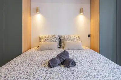a bedroom with a bed with two towels on it at Bright 3 rooms apartment close to Place Massena in Nice
