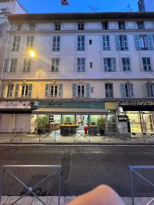 a building on the side of a street at Appartement Neuf Nice Carré Or à 2 pas de la mer tout équipé in Nice
