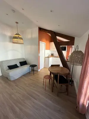 a bedroom with a bed and a table in a room at Appartement Neuf Nice Carré Or à 2 pas de la mer tout équipé in Nice