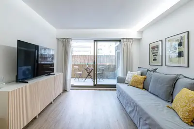 a living room with a couch and a television at MY CASA - SUISSE - Cosy Apartment Down Town with terrasse in Nice