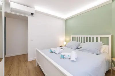 a bedroom with a white bed with towels on it at MY CASA - SUISSE - Cosy Apartment Down Town with terrasse in Nice