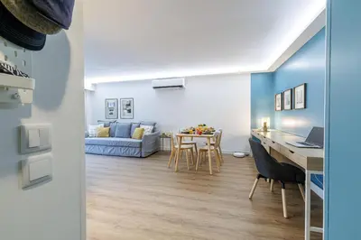 a kitchen and living room with a table and chairs at MY CASA - SUISSE - Cosy Apartment Down Town with terrasse in Nice