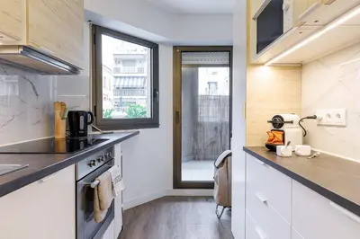 a kitchen with a counter top and a window at MY CASA - SUISSE - Cosy Apartment Down Town with terrasse in Nice