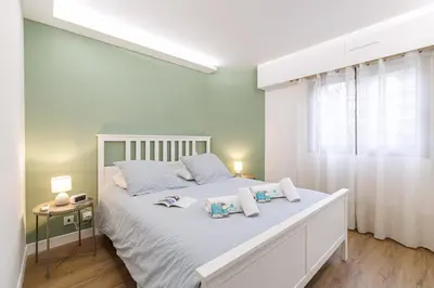 a white bedroom with a large bed with two pillows at MY CASA - SUISSE - Cosy Apartment Down Town with terrasse in Nice