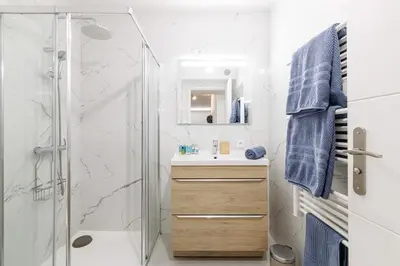 a white bathroom with a shower and a sink at MY CASA - SUISSE - Cosy Apartment Down Town with terrasse in Nice