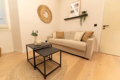 a living room with a couch and a table at Charmant Duplex Vieux Nice, proche mer, WiFi, Clim in Nice