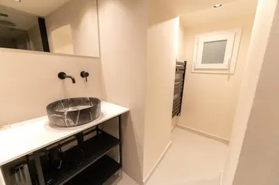 a bathroom with a sink and a mirror at Charmant Duplex Vieux Nice, proche mer, WiFi, Clim in Nice