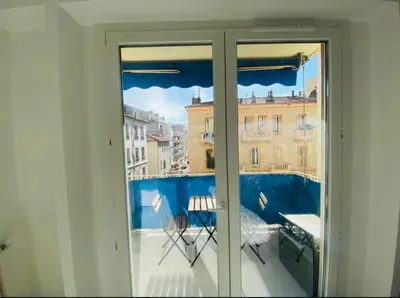 a room with a balcony with a view of a building at Magnifique studio avenue des diables bleus in La Celle-sous-Gouzon