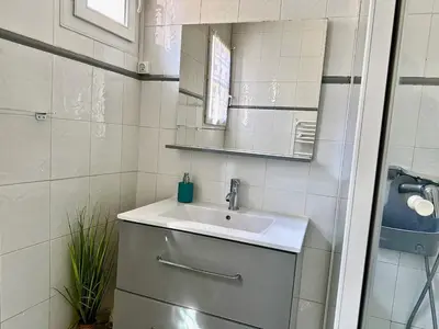 a bathroom with a sink and a mirror at Studio cosy proche des plages & promenade in Nice