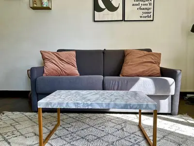 a blue couch with a coffee table in a living room at Studio cosy proche des plages & promenade in Nice