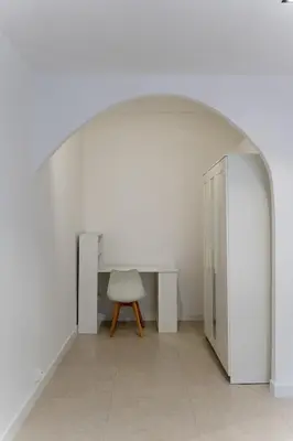 a white room with a table and a chair at Bright apartment in Nice in Nice
