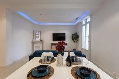 a dining room with a table and a blue ceiling at Bright apartment in Nice in Nice