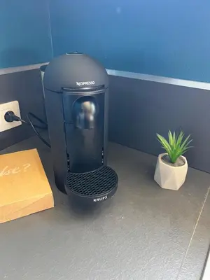 a black cpu sitting on the floor next to a plant at Sea view appartment in Nice