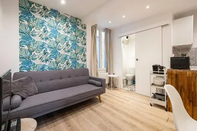 a living room with a couch and a blue wall at Cozy Apartment a-c 1BR-2P - Nice in Nice