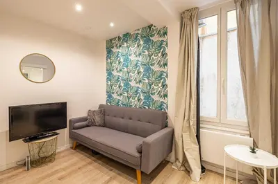 a living room with a couch and a tv at Cozy Apartment a-c 1BR-2P - Nice in Nice